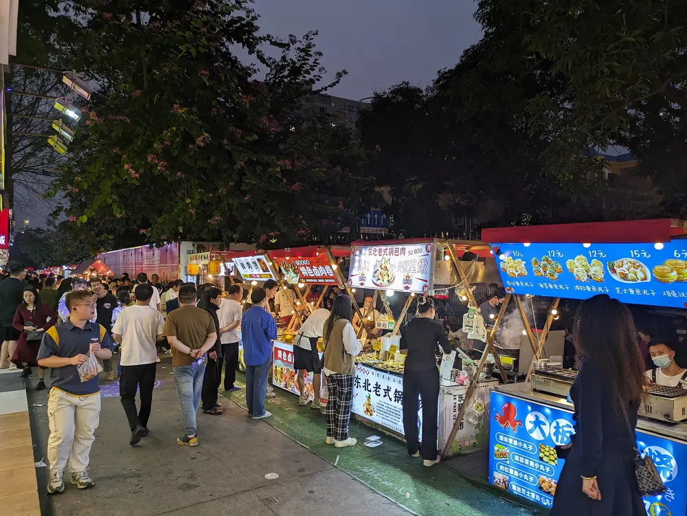 Crowds browsing food stalls at a night market in China