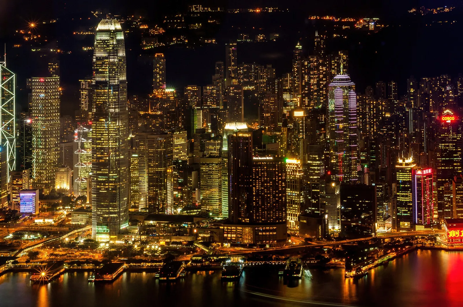 Hong Kong Island's skyline lit up at night across Victoria Harbour